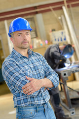 Portrait of workman, arms crossed