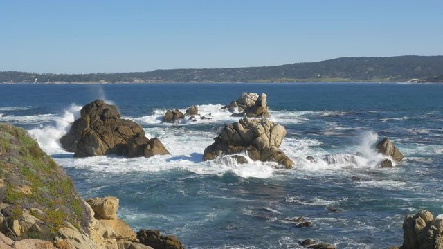 Wave crashing over rocks in  Point Lobos State Reserve, California, USA.
