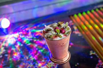cocktail in metal glass with psicadelic lights
