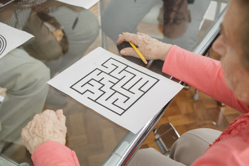 elderly woman trying brain teasers