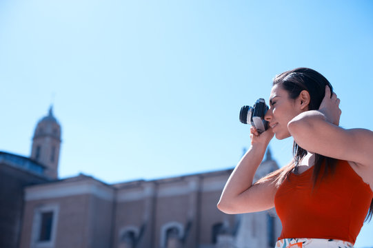 Young woman taking pictures in Rome