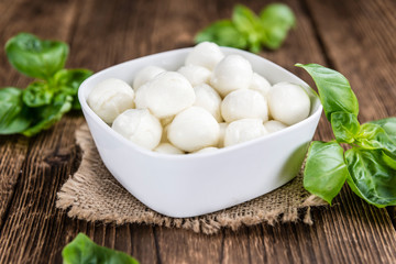 Mozzarella (on wooden background)