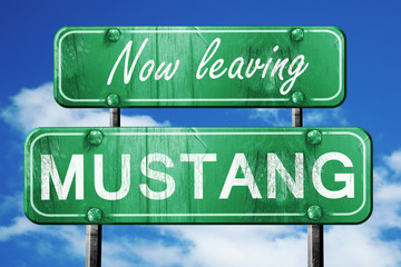 Leaving mustang, green vintage road sign with rough lettering