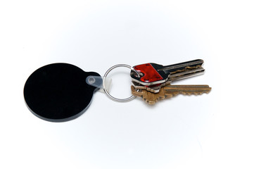 keyring with three keys over white and black blank fob