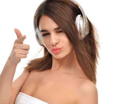brunette woman listening and enjoying music in gold headphones