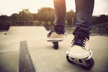 skateboarding legs on free line at skatepark ramp