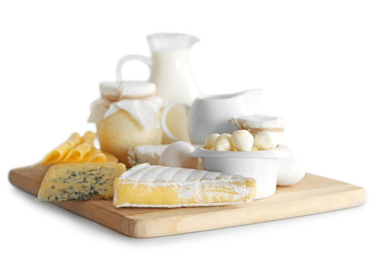Set of fresh dairy products on wooden board, isolated  on white