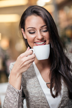 business woman enjoying coffee in a cafe bar