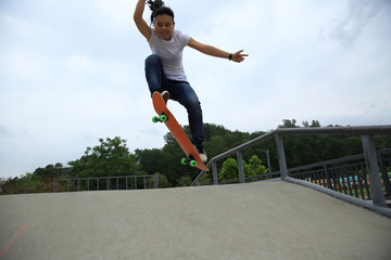 young skateboarder skateboarding at skatepark