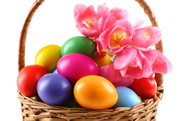 Multicoloured Easter eggs in basket isolated on white