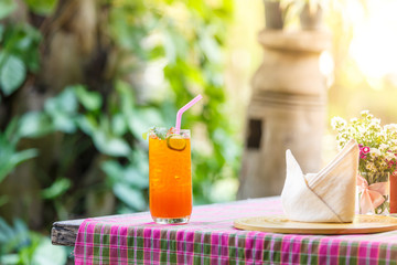 tea cocktail with lemon and ice on table