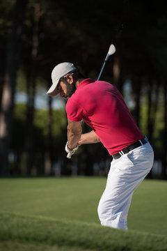 golfer hitting a sand bunker shot