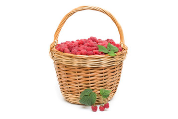 Fototapeta na wymiar Fresh ripe red raspberries in a wicker bowl 