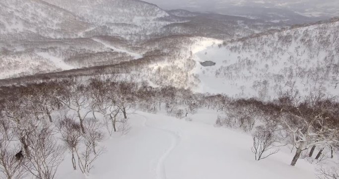 Aerial Follow Skier in Hokkaido, Japan Mountains