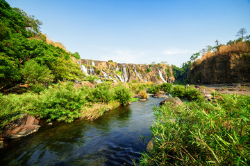 Fototapeta na wymiar The Da Nhim River with crystal clear water among green trees