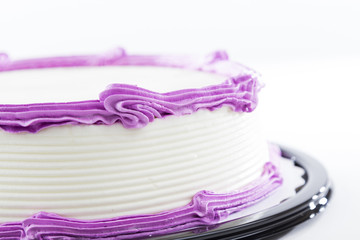 Cake with plain frosting and space for text on a bright background