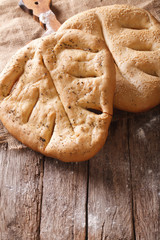 Fugasse French bread closeup on the table. vertical, rustic
