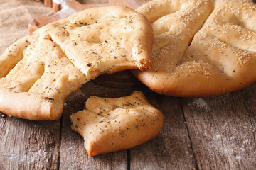 Fougasse French bread with sesame seeds and herbs closeup. Horizontal
