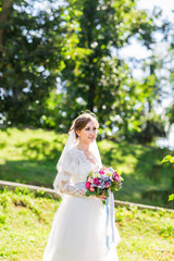 Fototapeta na wymiar Wedding flowers ,Woman holding colorful bouquet with her hands on wedding day
