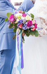 Wedding flowers ,Woman holding colorful bouquet with her hands on wedding day
