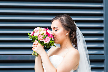 Beautiful wedding bouquet in hands of the bride