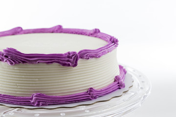 Cake with plain frosting and space for text on a bright background