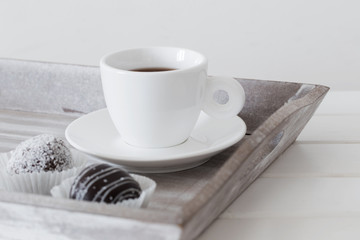 Sweet chocolate cake with cup on wooden tray