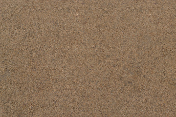 Wet sand. Texture.
Smooth surface of wet sand is dark yellow in color.