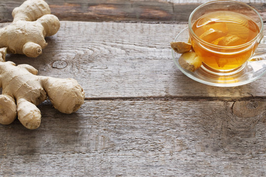 cup of ginger tea on a wooden table