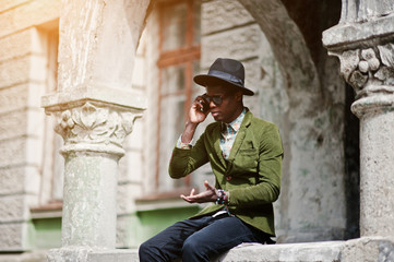 Fashion portrait of black african american man on green velvet j