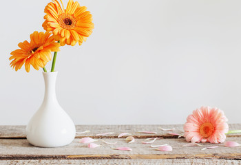 Gerbera in vase on old wooden table