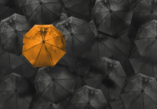 Fototapeta orange umbrella on black different business concept