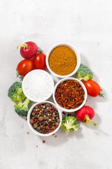 assortment of pepper, salt, spices and fresh vegetables