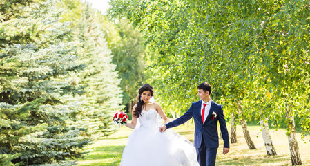 Stylish beautiful happy bride and groom, wedding celebrations outdoors