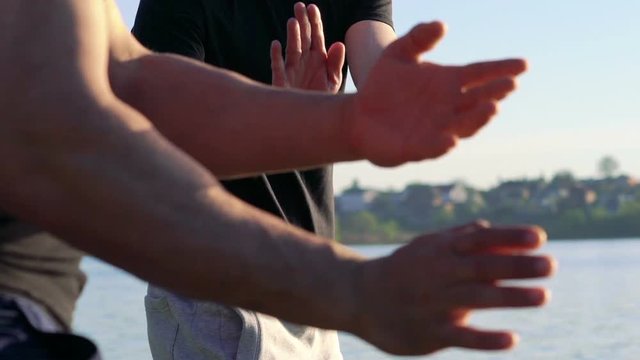 The performance of Wing Chun between masters near the river. Slowly