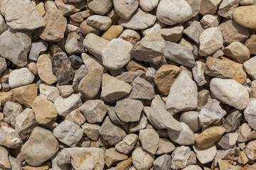 Grey yellow brown black natural boulders background directly from above