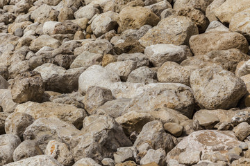 Grey yellow brown black natural boulders background from side