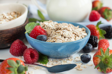 Rolled oats in a bowl with berries  and milk