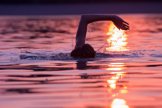 Swimming in sunset/sunrise with tropical colors.