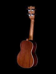 Naklejka premium back of hawaii ukulele guitar isolated against black background