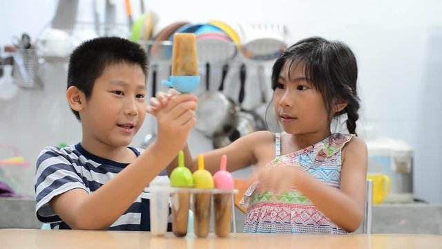Asian children eating homemade ice cream 