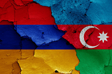 flags of Armenia and Azerbaijan painted on cracked wall