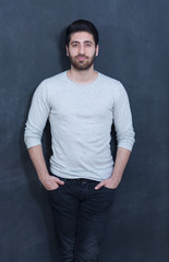 Man standing in front of black chalkboard backgrou nd