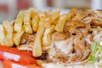 Greek gyros, souvlaki,meat, fried potatoes, tomatoes and onions, Athens Greece, national food, traditional Greek cuisine