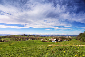 Spring green hills blooming. Valley behind the foothills