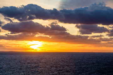 Fototapeta premium Orange Sunset Under Black Clouds