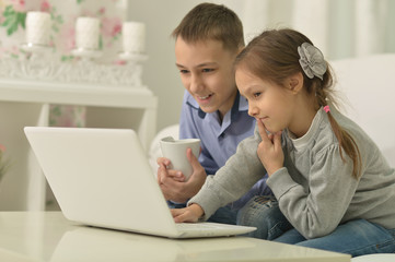 Children with laptop at home