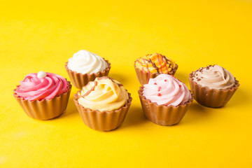 Chocolate cupcakes with yellow backgroud