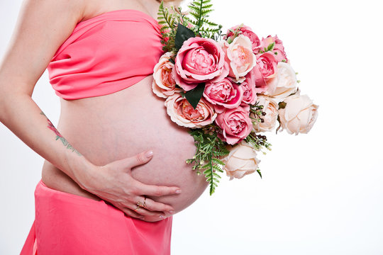 belly of a pregnant woman in pink with flowers