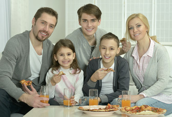family at home with pizza
